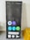 A large rectangular item resembling a smartphone screen is displayed, featuring various app icons on a dark background. The icons include popular social media and communication apps, arranged in a grid. The upper part shows symbols for time, battery, and network, while the lower portion has a navigation bar and app buttons.
