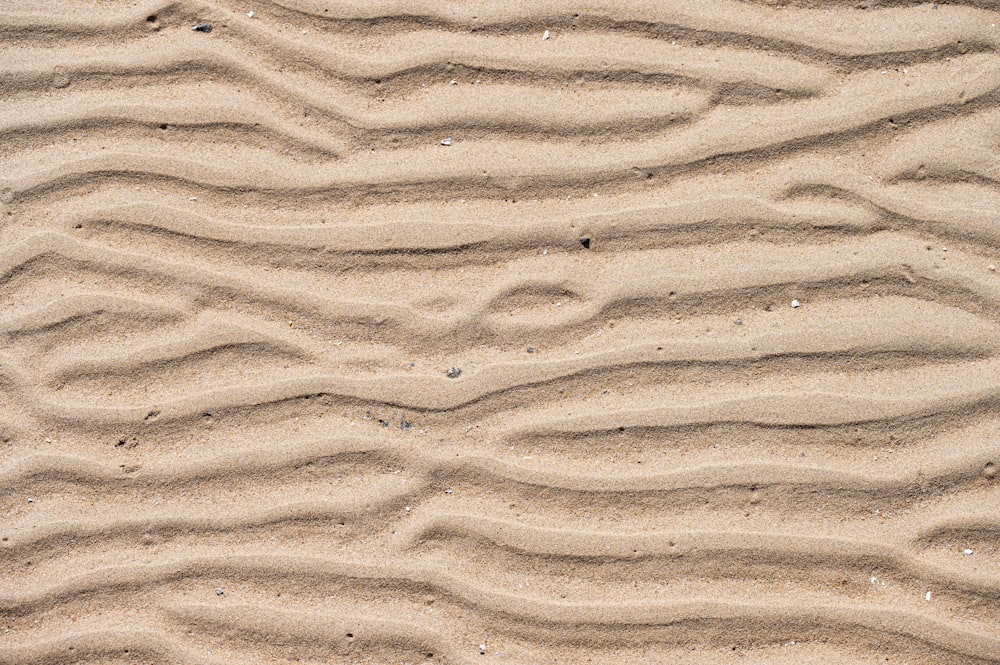 a close up of sand with wavy lines