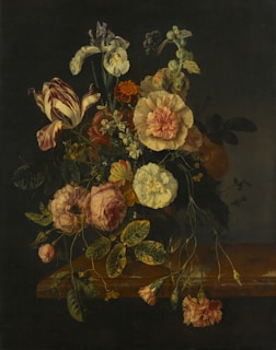 A still life arrangement featuring flowers in a vase.