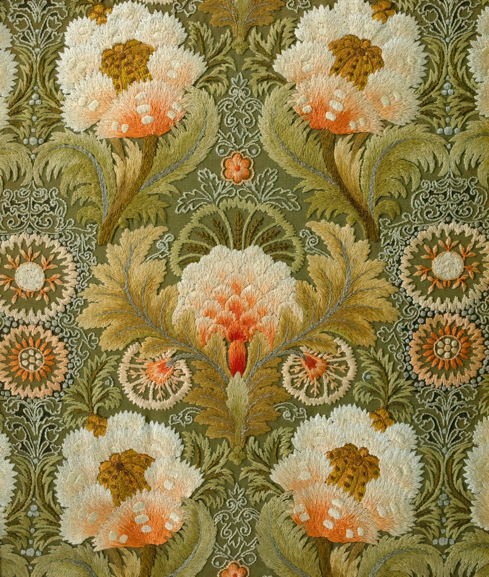 a large floral design on a green background