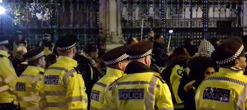 Uniformed security personnel managing crowd control at a large event.