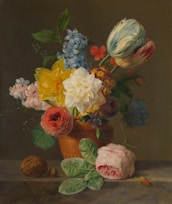A still life painting depicting a variety of flowers artistically arranged in a terracotta pot. The composition includes tulips, roses, daffodils, and various other blooms in vibrant colors. Green leaves and petals surround the arrangement, and a walnut and small fruit are placed beside the pot. The background is a muted brown, emphasizing the colorful flowers.
