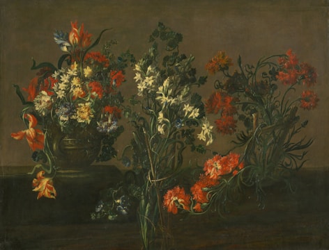 An arrangement of diverse flowers with vibrant red, white, and orange petals set in a dark, earthy background. The flowers are placed in an ornate vase and exhibit intricate details of leaves and stems intertwined. The composition creates a sense of depth and texture, highlighting the delicate nature of each bloom.