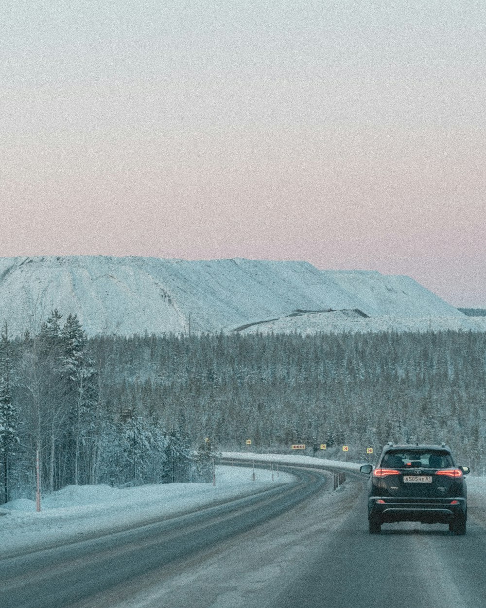 a car is driving down a snowy road