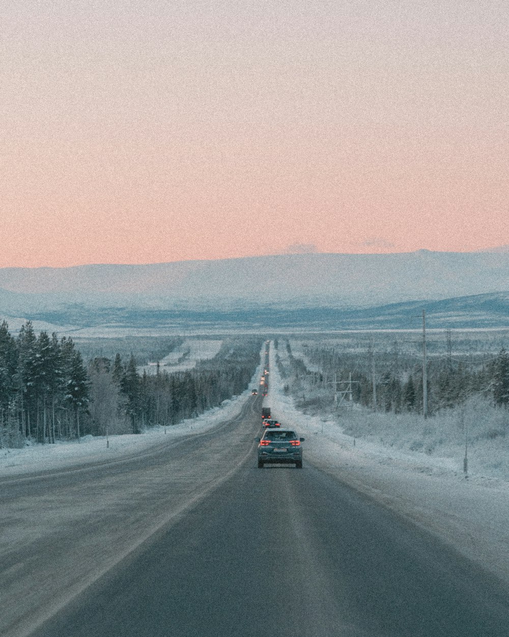 a car is driving down a snowy road