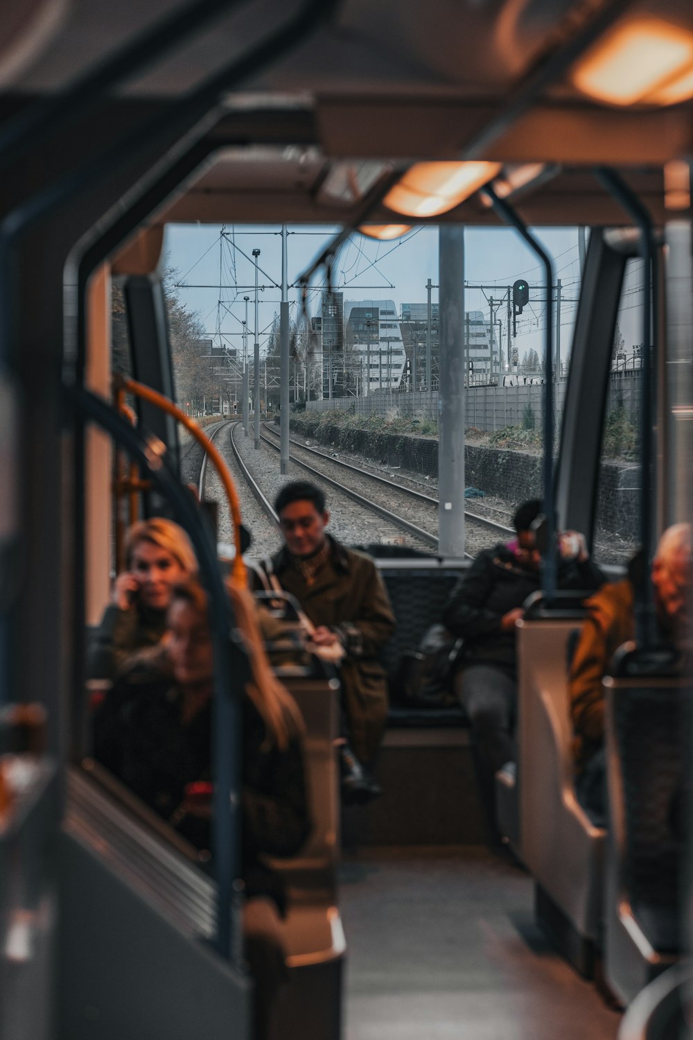 a group of people sitting on a train next to each other