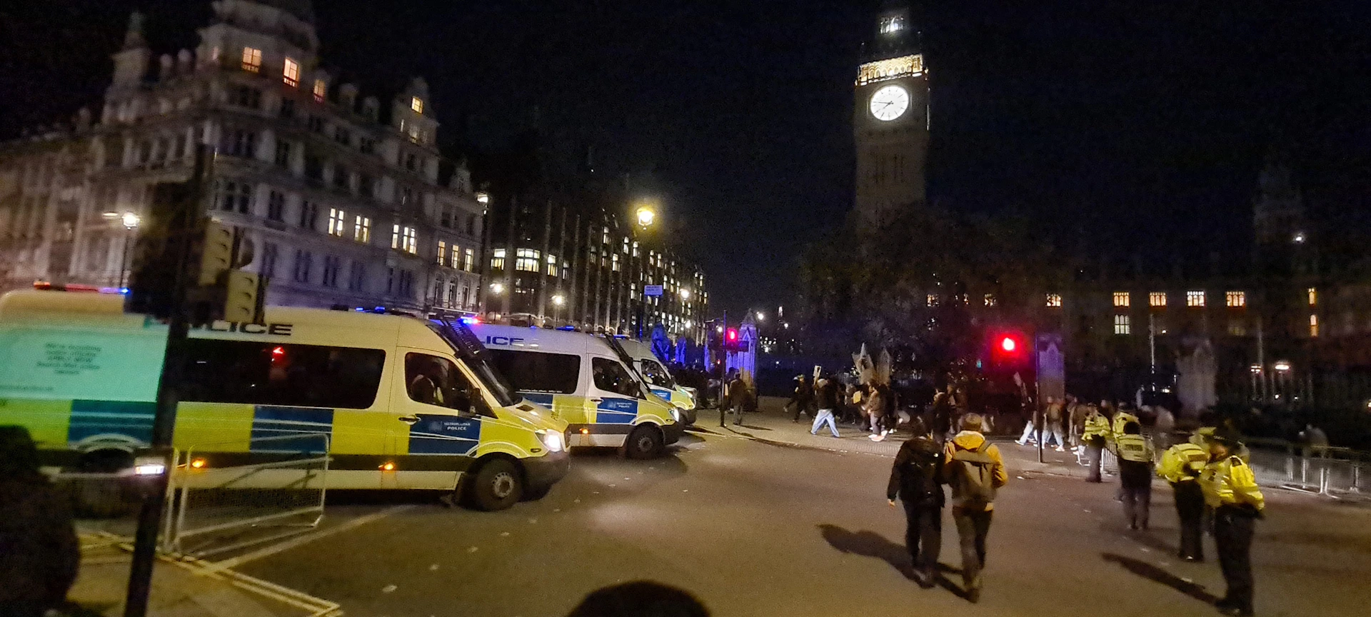 A dramatic nighttime scene of police cars cornering a getaway vehicle under city lights.