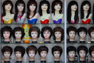 a display case filled with lots of mannequin heads