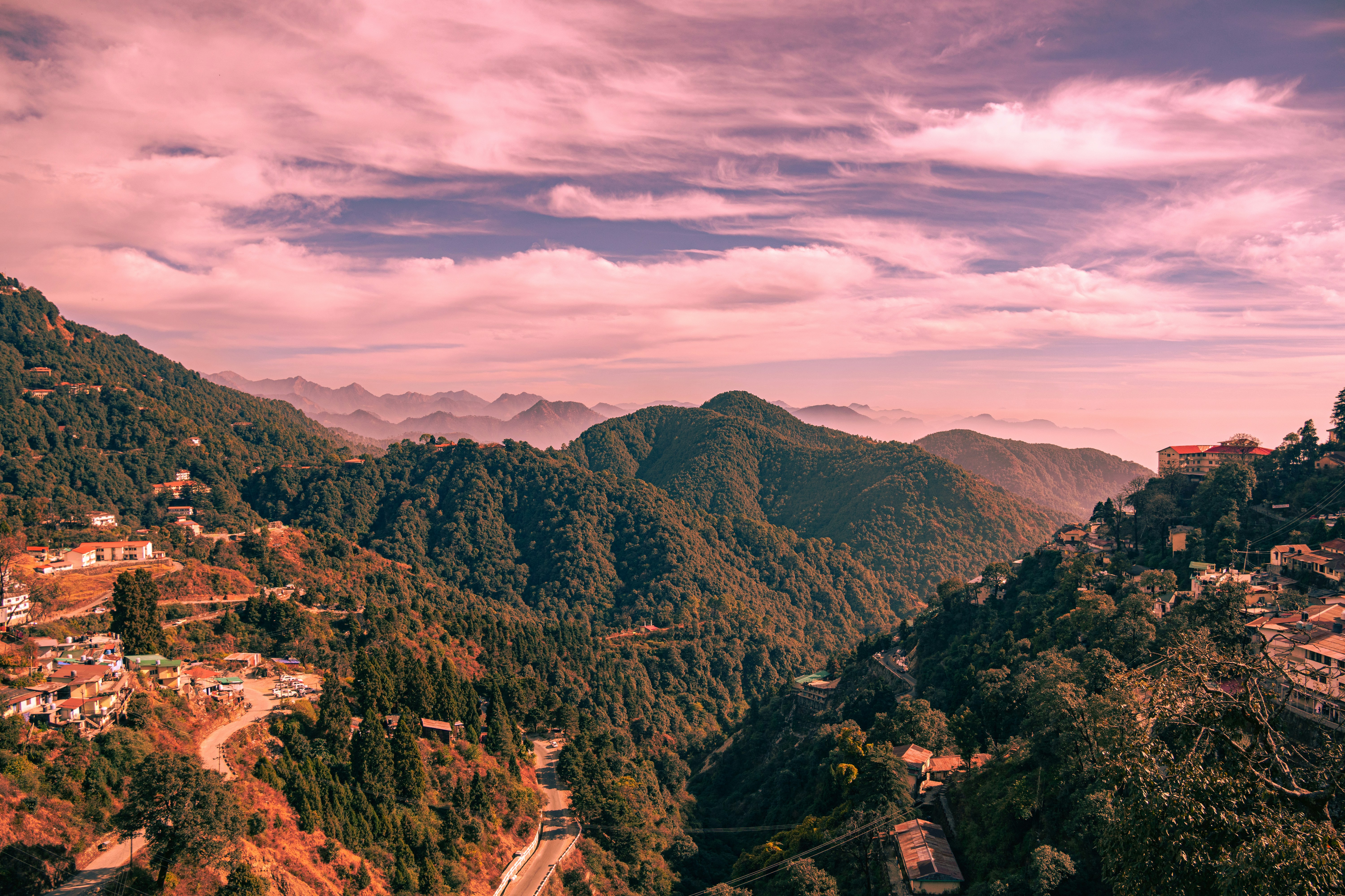 a scenic view of a village in the mountains