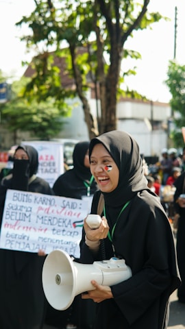 A group of smiling community members holding 'trunk' meme coin signs at a casual meetup