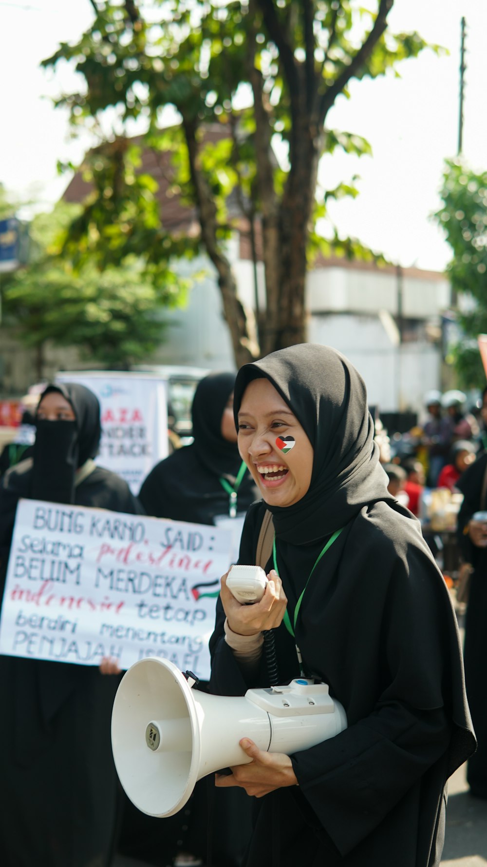 a woman holding a megaphone and a sign