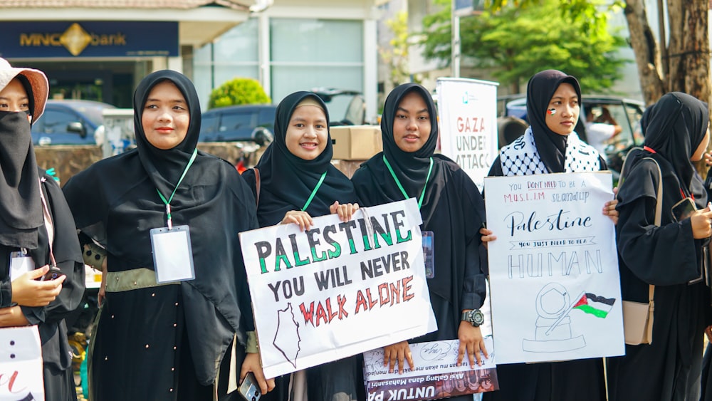 a group of women holding placares and signs