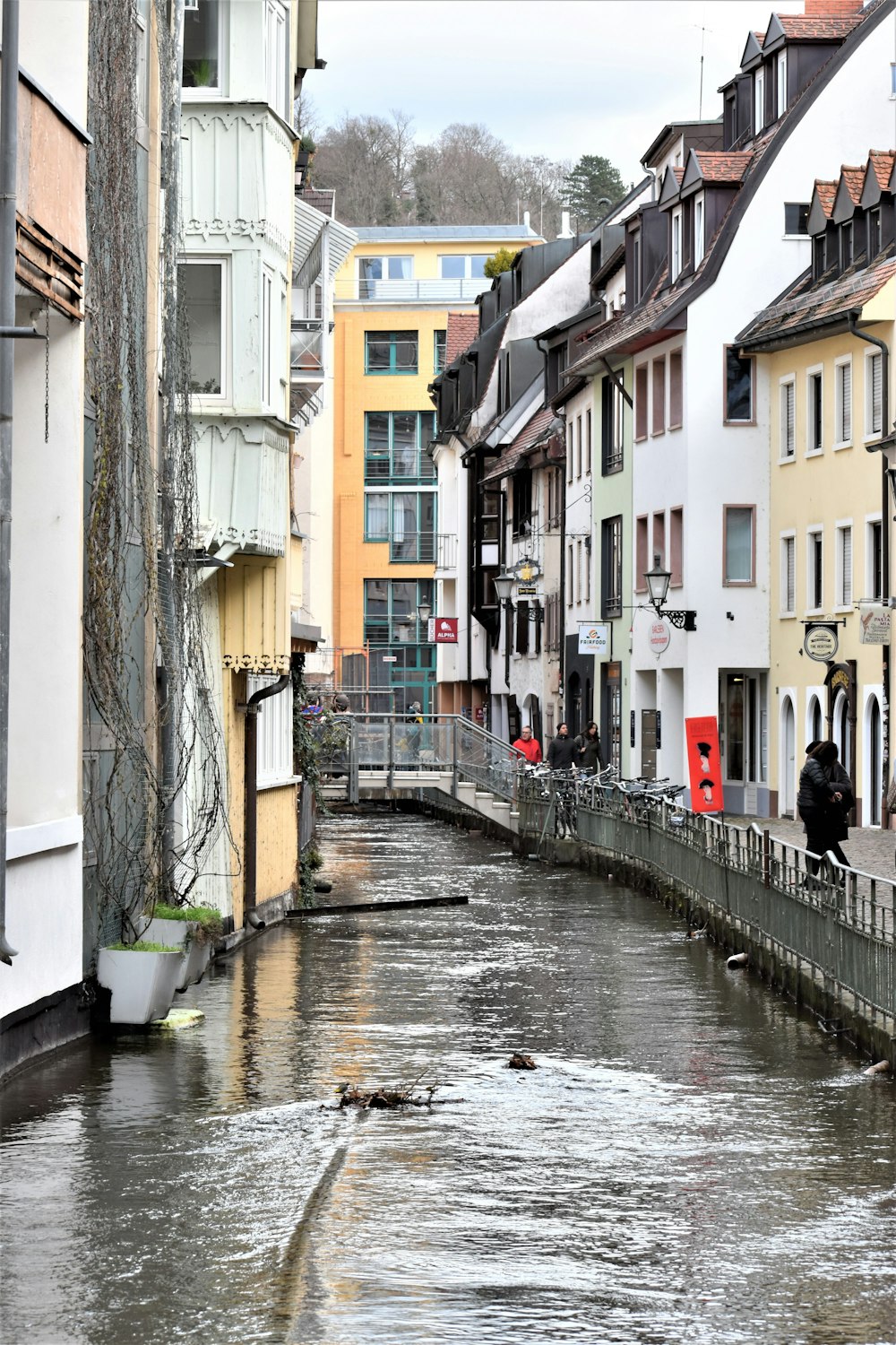 a river running through a city next to tall buildings