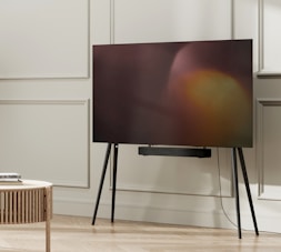 a flat screen tv sitting on top of a wooden table