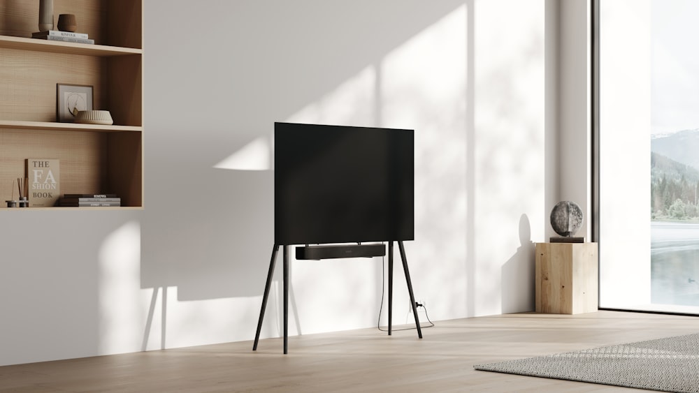 a flat screen tv sitting on top of a wooden stand