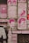 A series of colorful posters and murals are displayed on a brick wall. The art is primarily in pink tones, featuring various musicians and slogans like 'Move On Up,' 'Music Sounds Better With You,' and 'Another Dimension.' There are also images of cassette tapes and stylized portraits of famous musicians.
