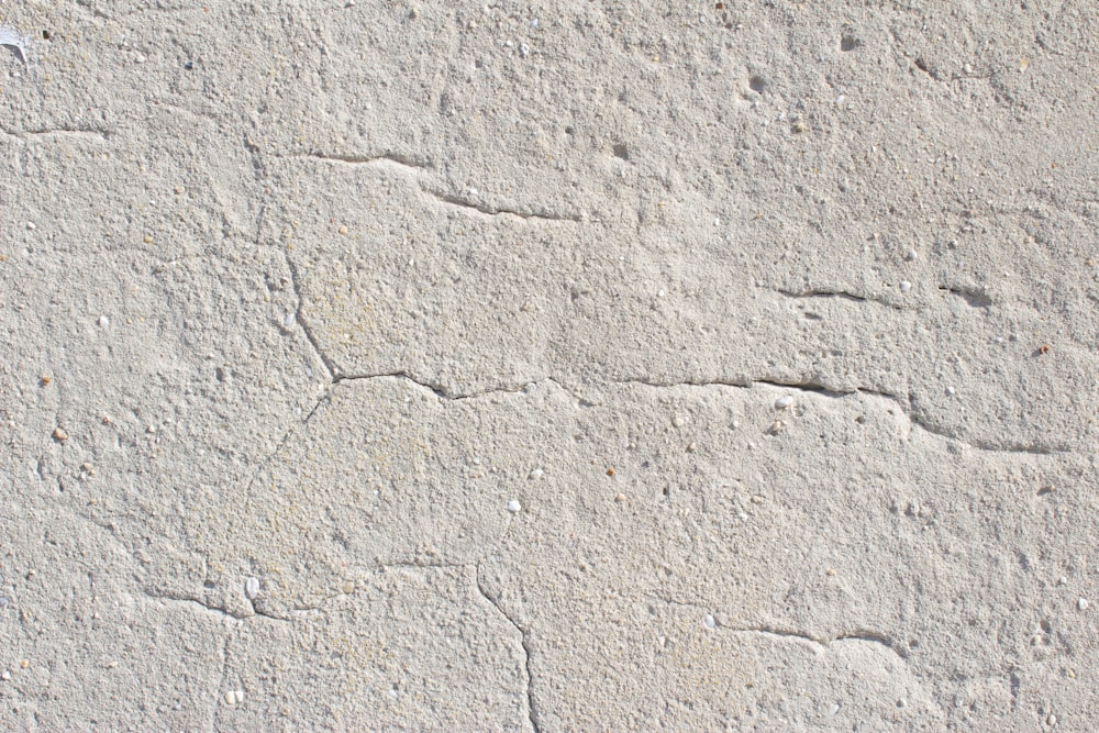 a cement wall with cracks in it