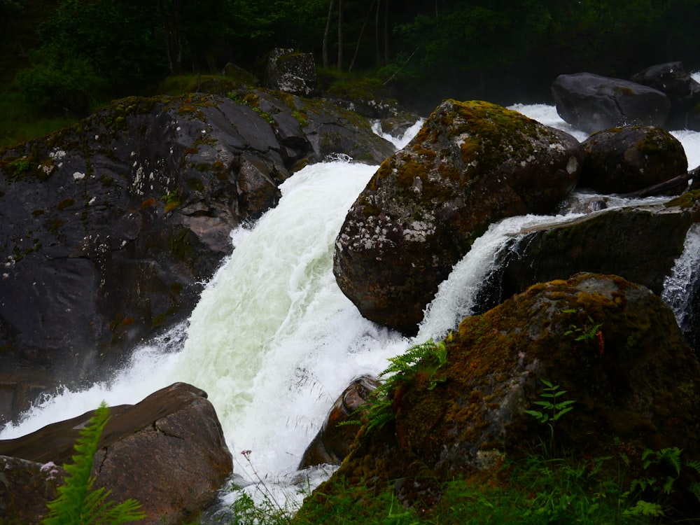 a waterfall with a bunch of rocks in the water