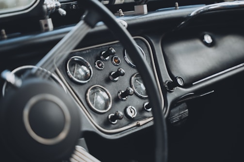 Close-up of bm 12's dashboard showing classic dials and steering wheel.