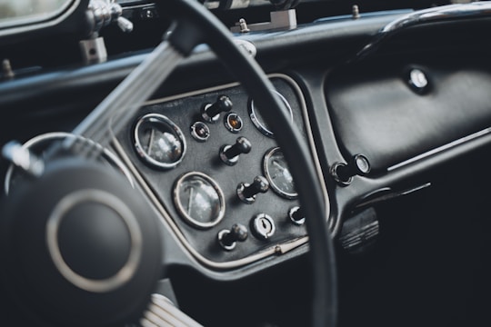 Close-up of a classic car's dashboard with modern digital overlays highlighting engagement stats.