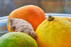 Tangy Virgin seasoning blend displayed alongside fresh citrus fruits.