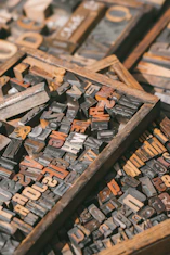 a pile of old wooden typewriters sitting on top of a table