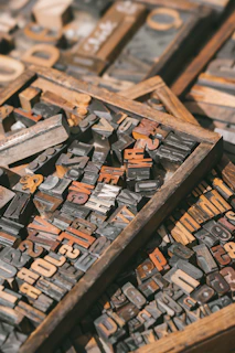 a pile of old wooden typewriters sitting on top of a table
