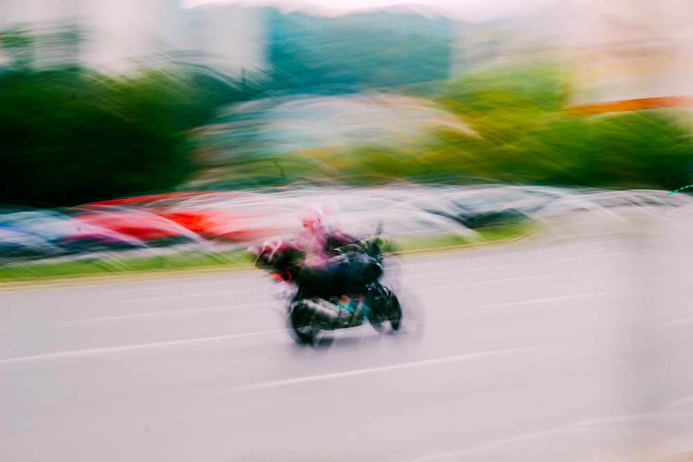 a blurry photo of a person riding a motorcycle
