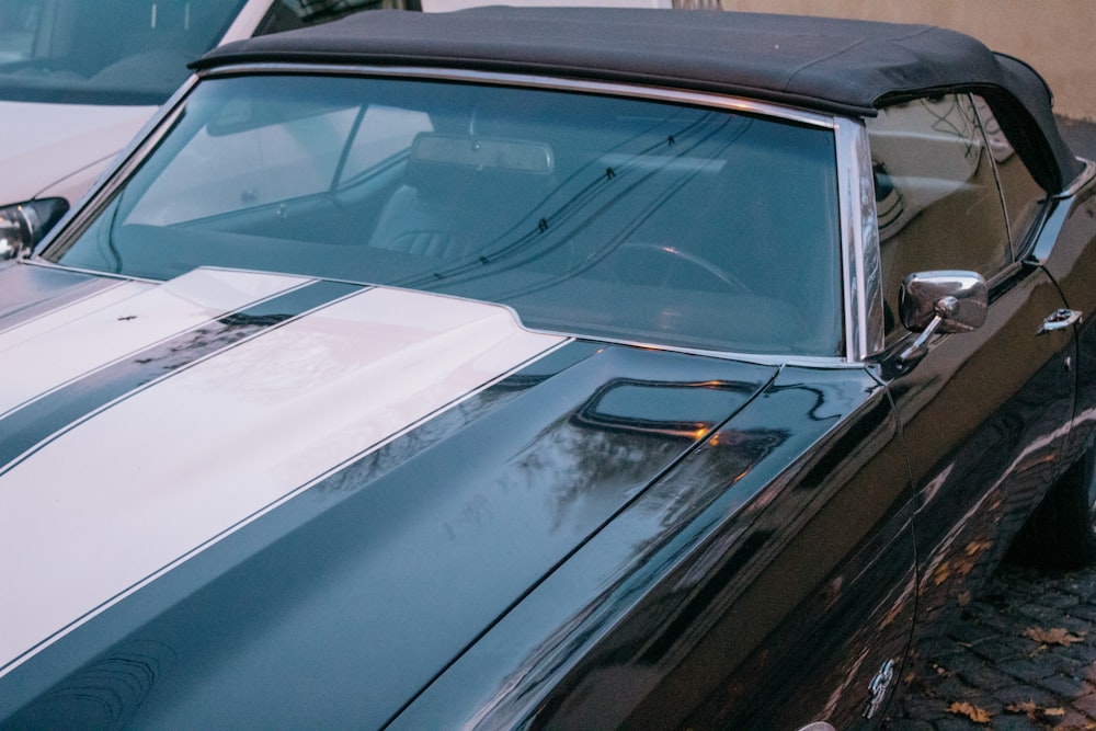 a black and white car parked next to another car