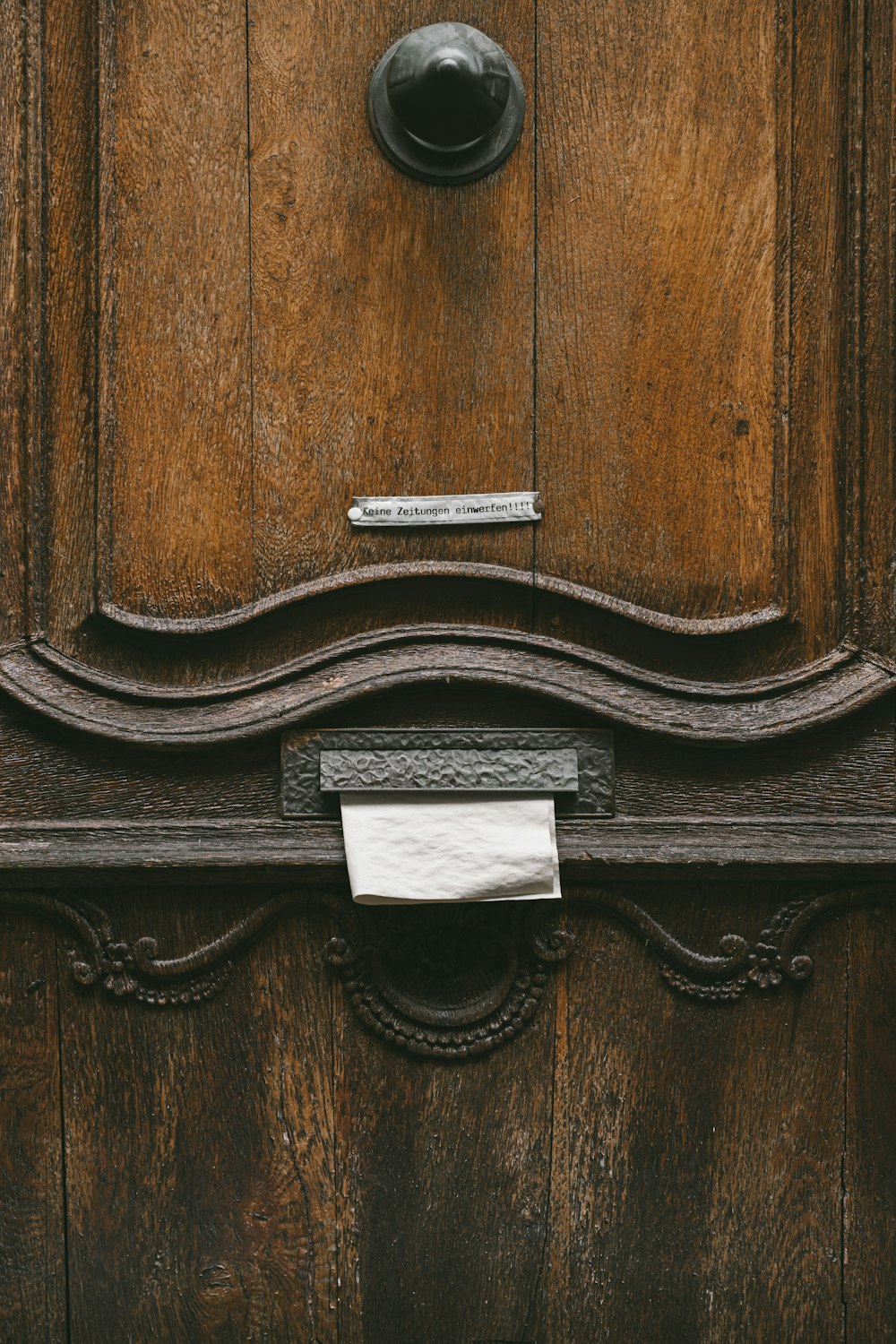 a close up of a wooden door with a sign on it