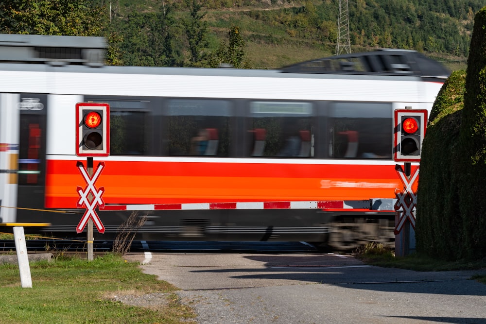 a red and white train traveling down train tracks