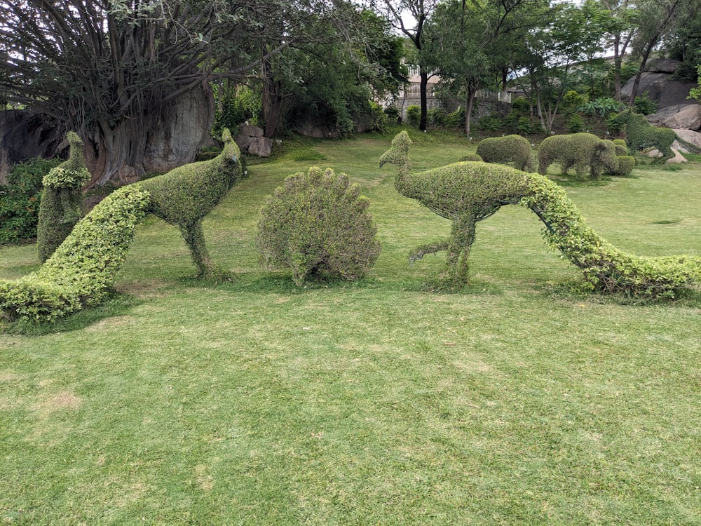 a couple of animals made out of bushes