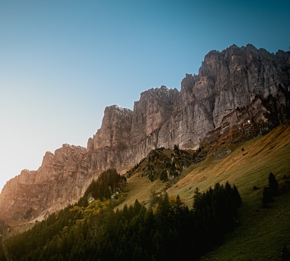 the sun is setting on a mountain range