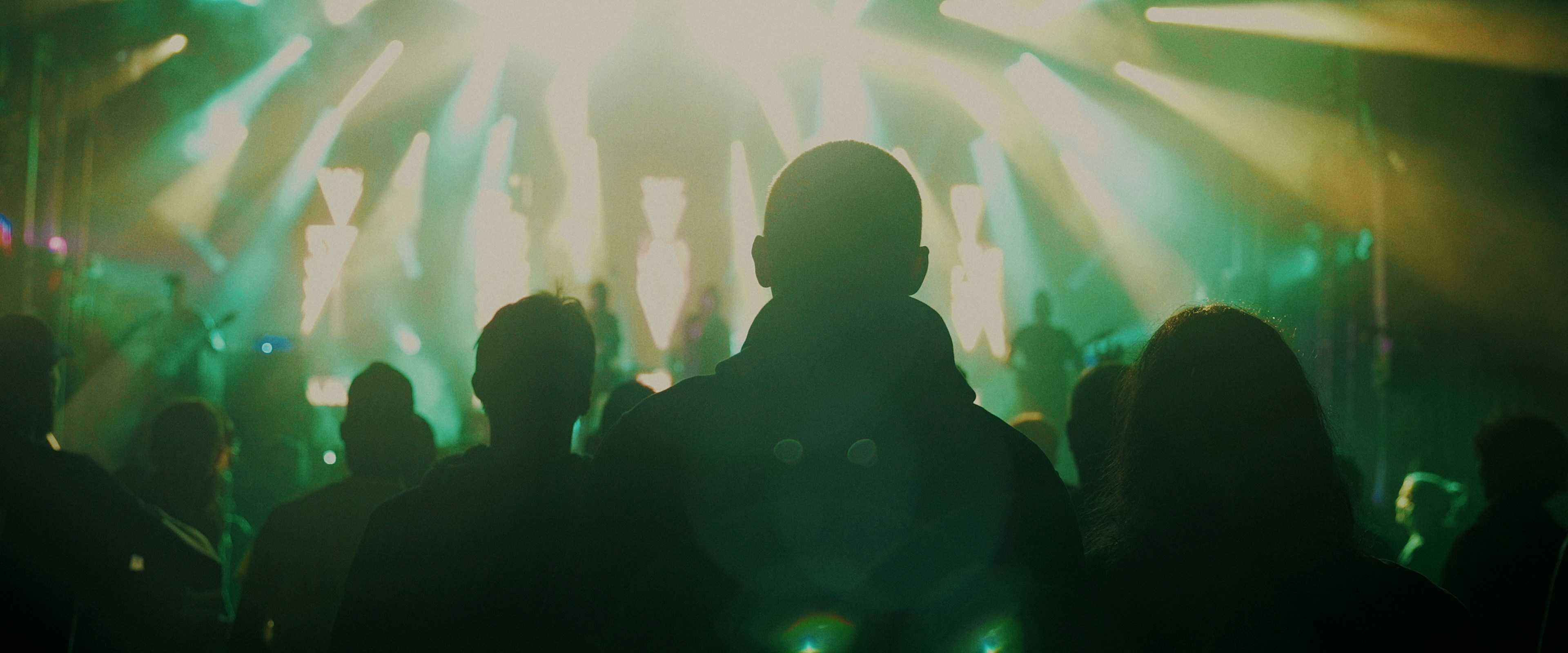 Concert stage with colorful lights and a performer silhouette