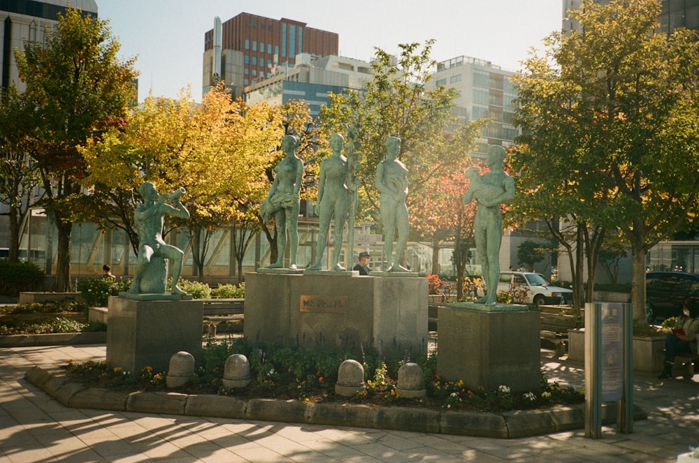 a statue of a group of people in a park