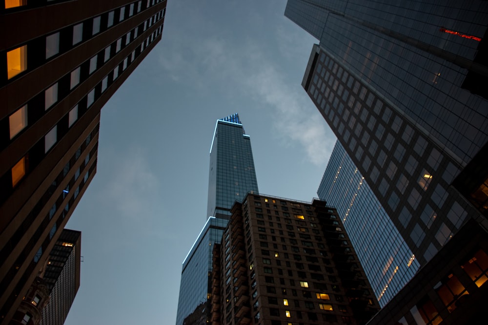 looking up at skyscrapers in a city at night