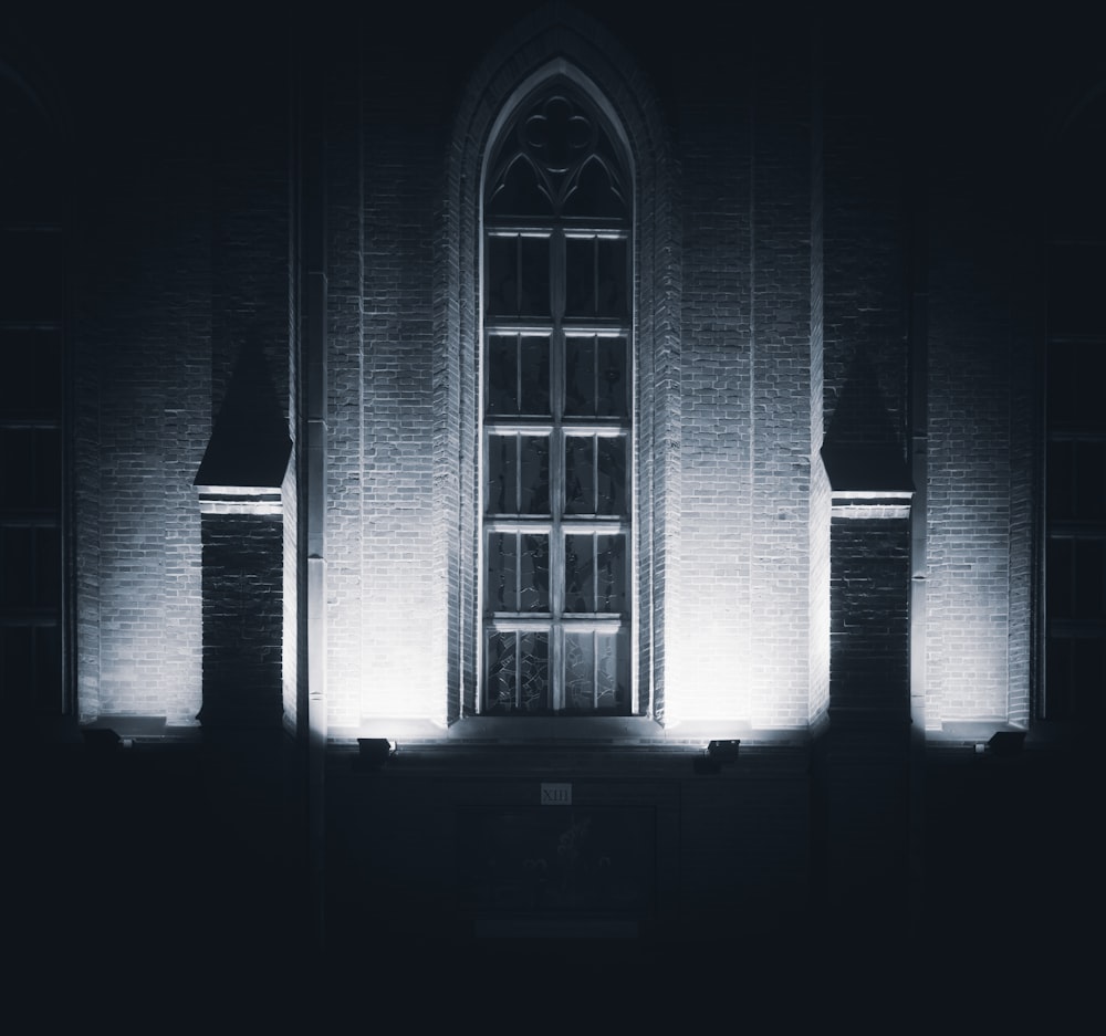 a black and white photo of a building at night