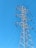 A towering metal electricity pylon stands against a clear blue sky. Several power lines extend from the structure, highlighting its function and connectivity.