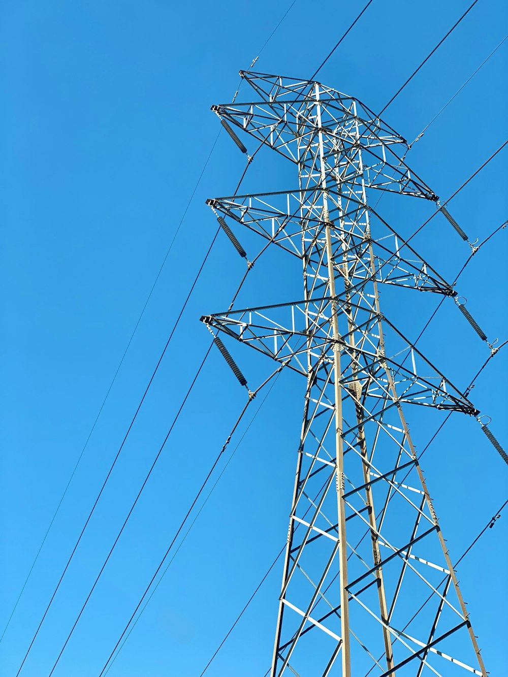 a tall metal tower with lots of wires on top of it