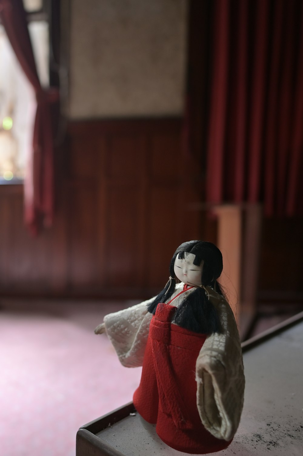 a doll sitting on top of a table in a room