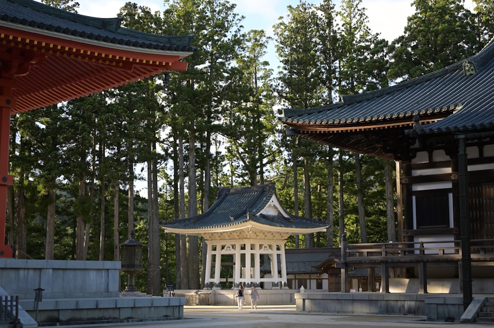 a pagoda in the middle of a park with trees in the background