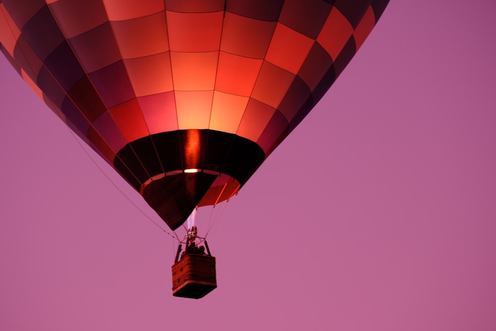 a large hot air balloon flying through a purple sky