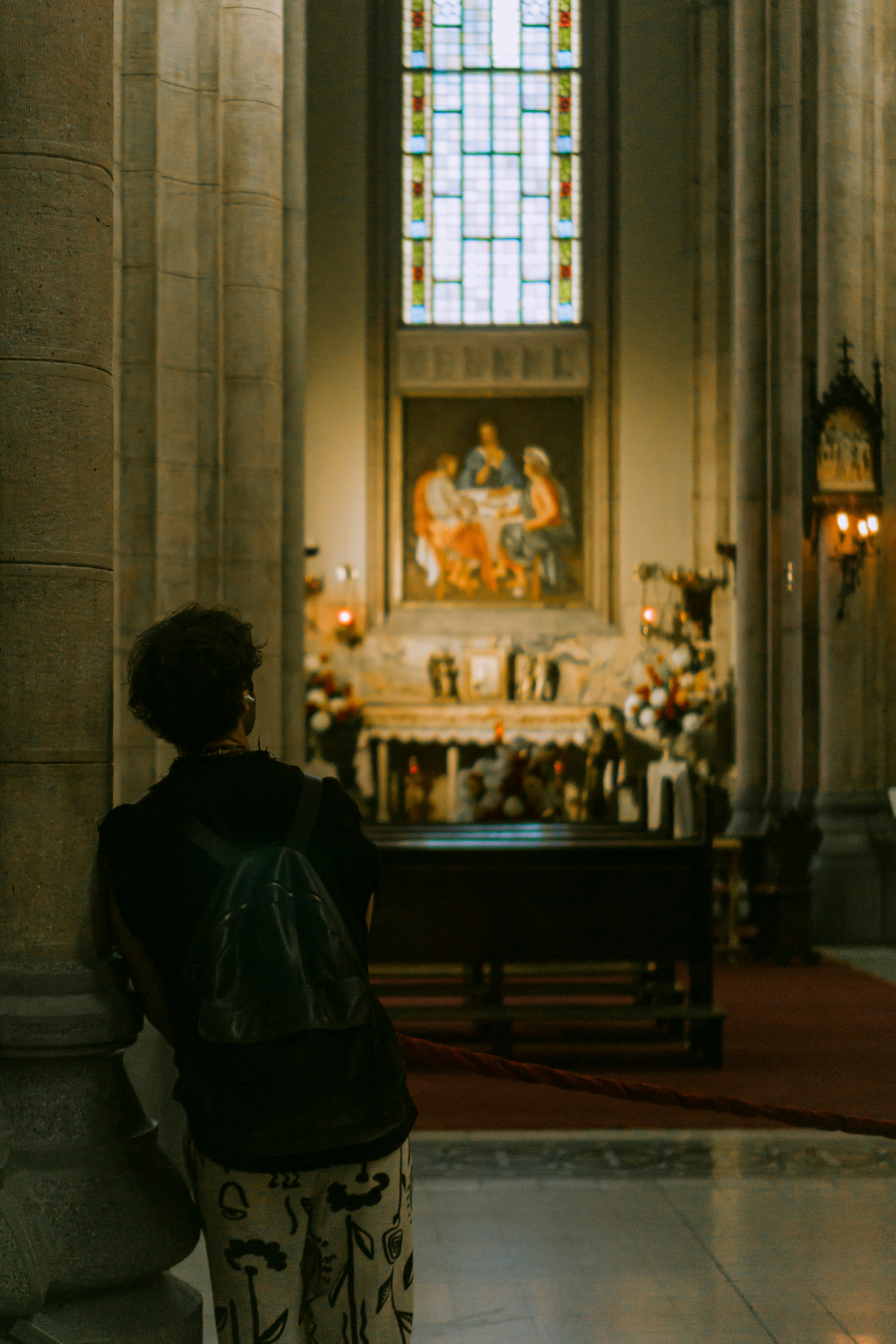a woman standing in front of a church alter