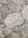 Rough stone tiles are laid out in an uneven pattern. The surfaces feature white and beige veins running across various shades of gray and brown. The texture appears rugged and natural, with some stones having sharper edges, while others seem more rounded.