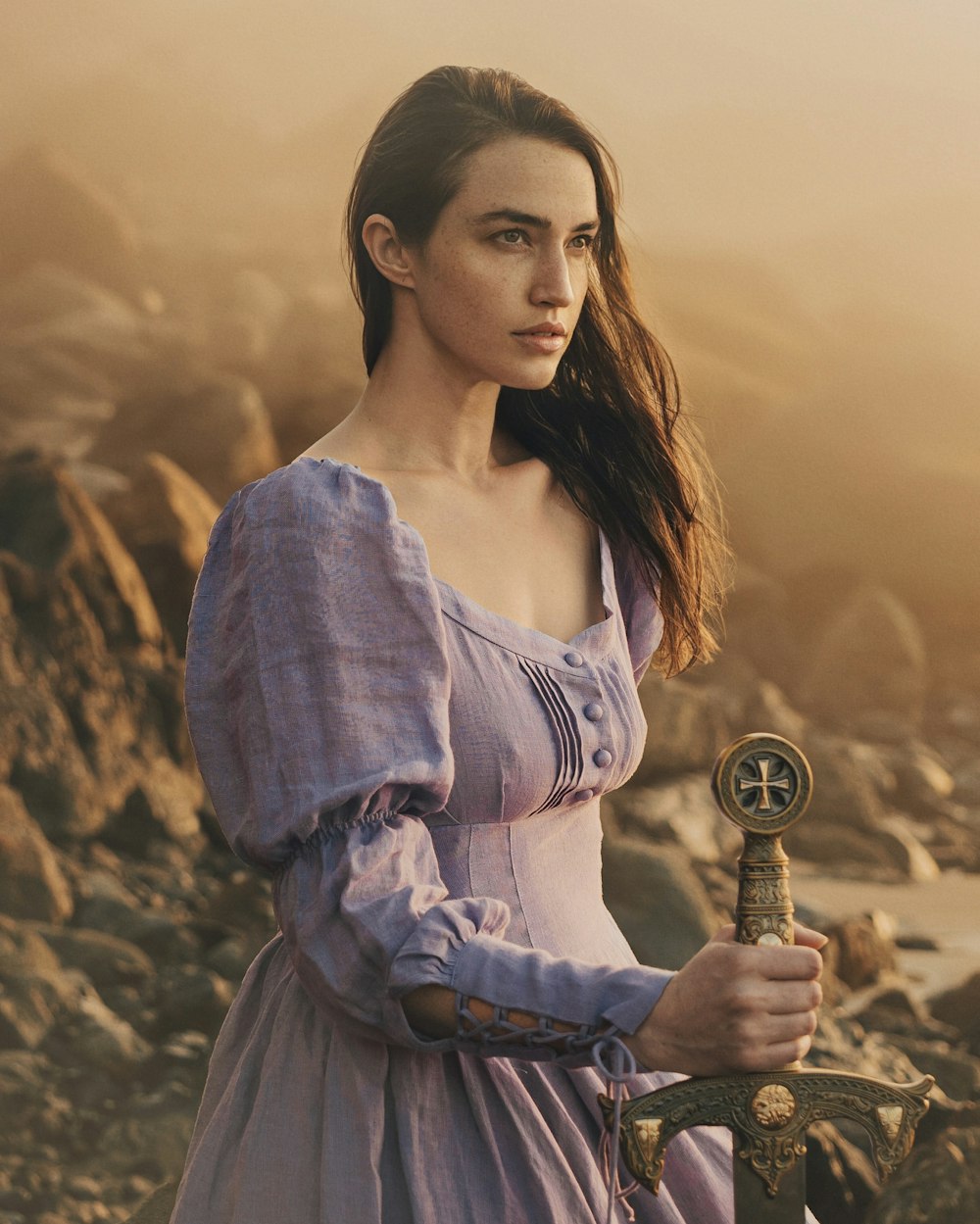 a woman in a purple dress holding a sword