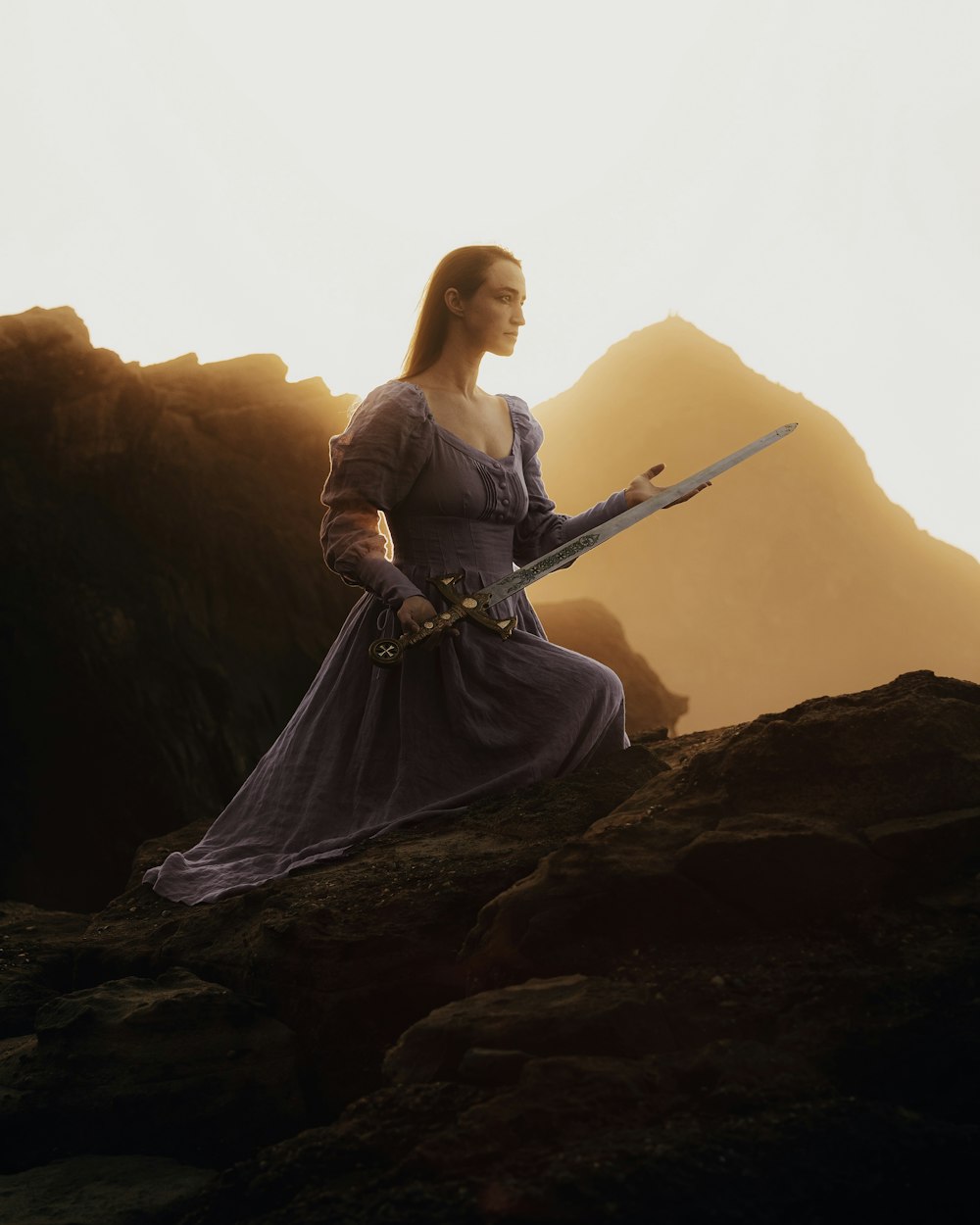 a woman in a purple dress holding a sword