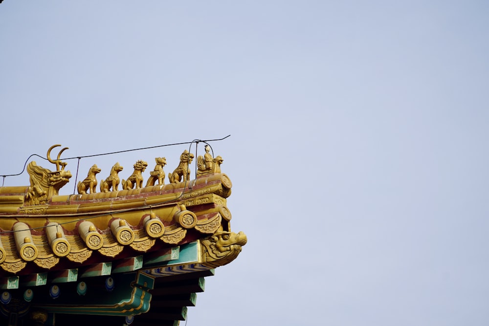 a golden roof with a bird on top of it