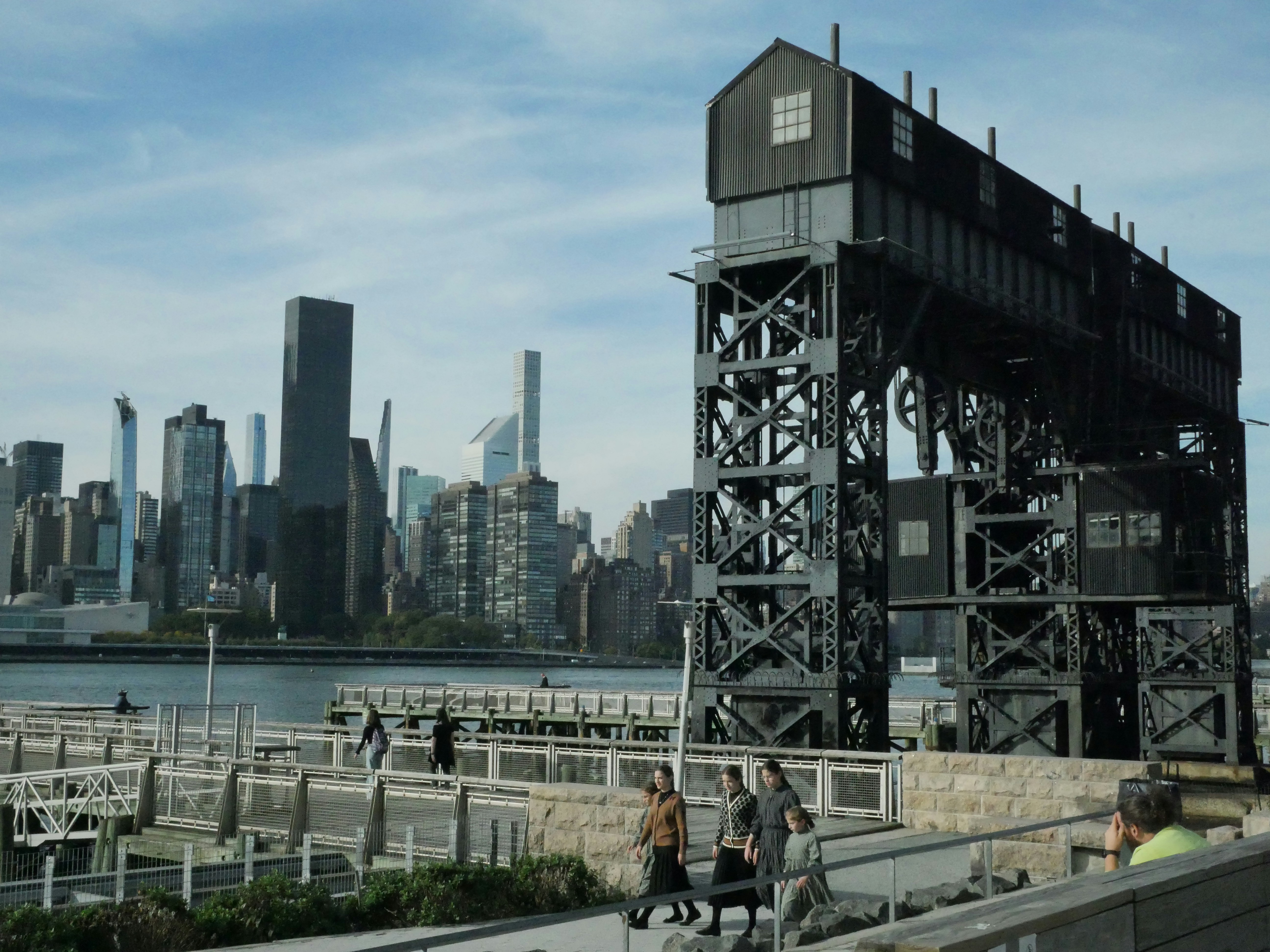 a group of people walking across a bridge