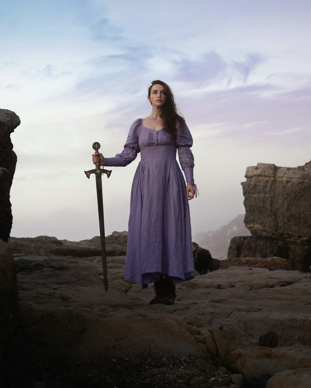 a woman in a purple dress holding a sword