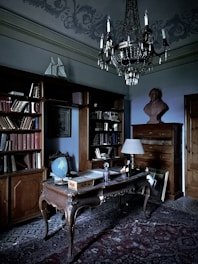 A refined study room with leather-bound journals and a golden quill pen resting on a polished wooden desk.
